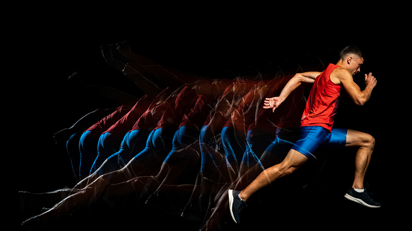 A sprinter against a black background, illustrating speed and acceleration.